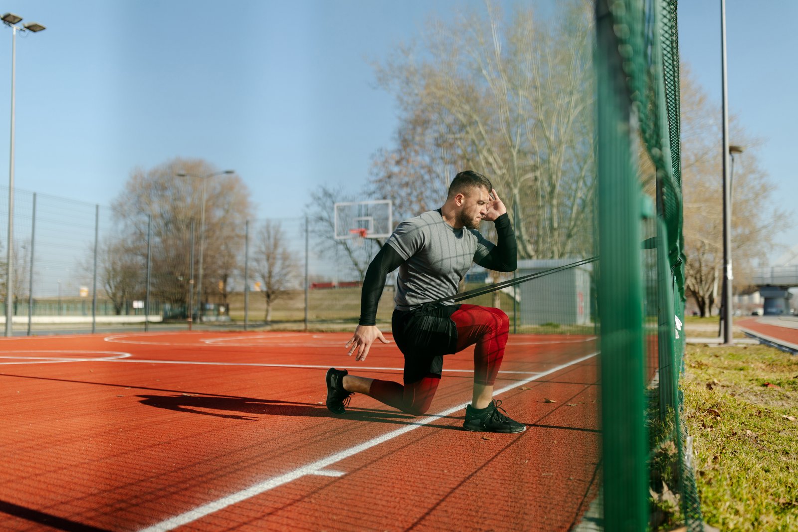 strong-man-stretching-legs-before-jogging-healthc-2023-11-27-05-36-59-utc